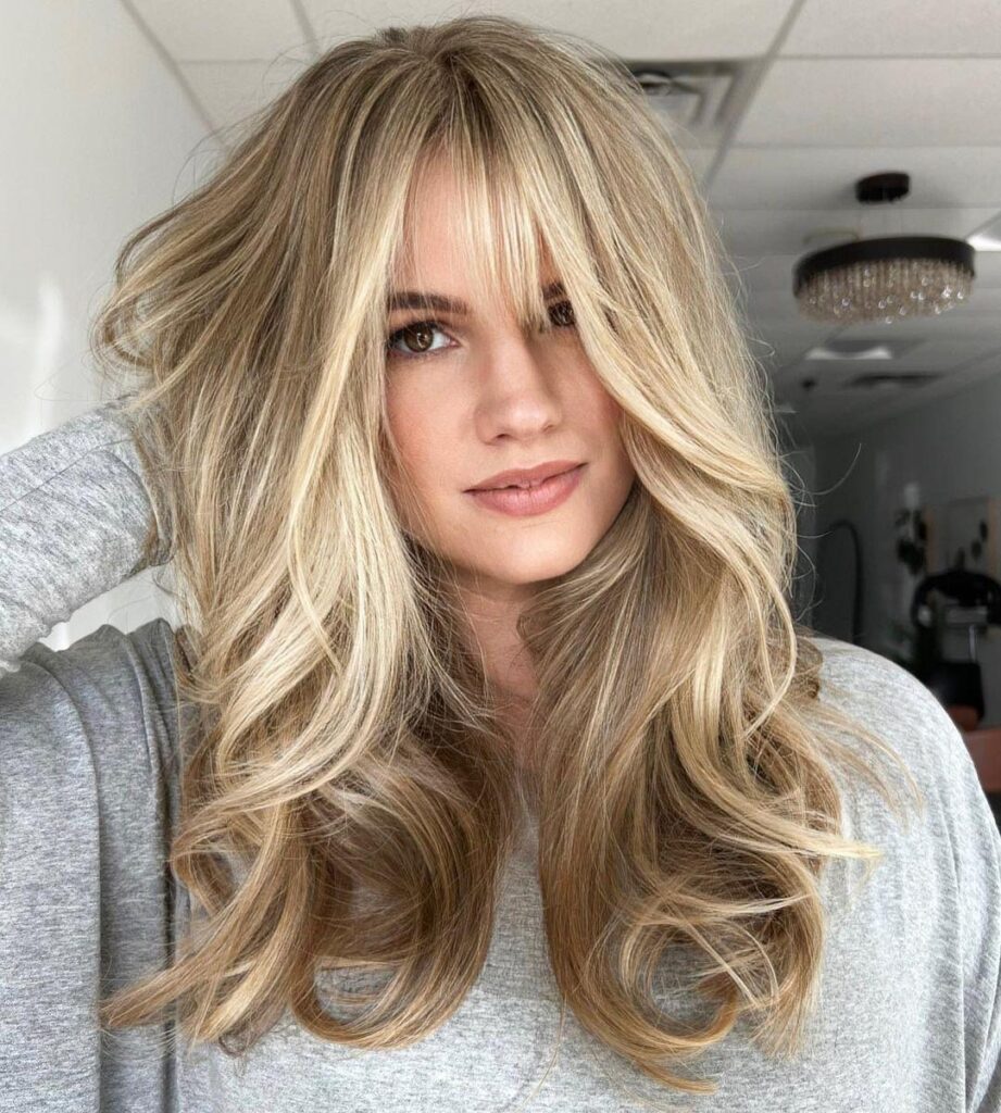 Blonde Baby Lights With Long Layers and Curtain Bangs
