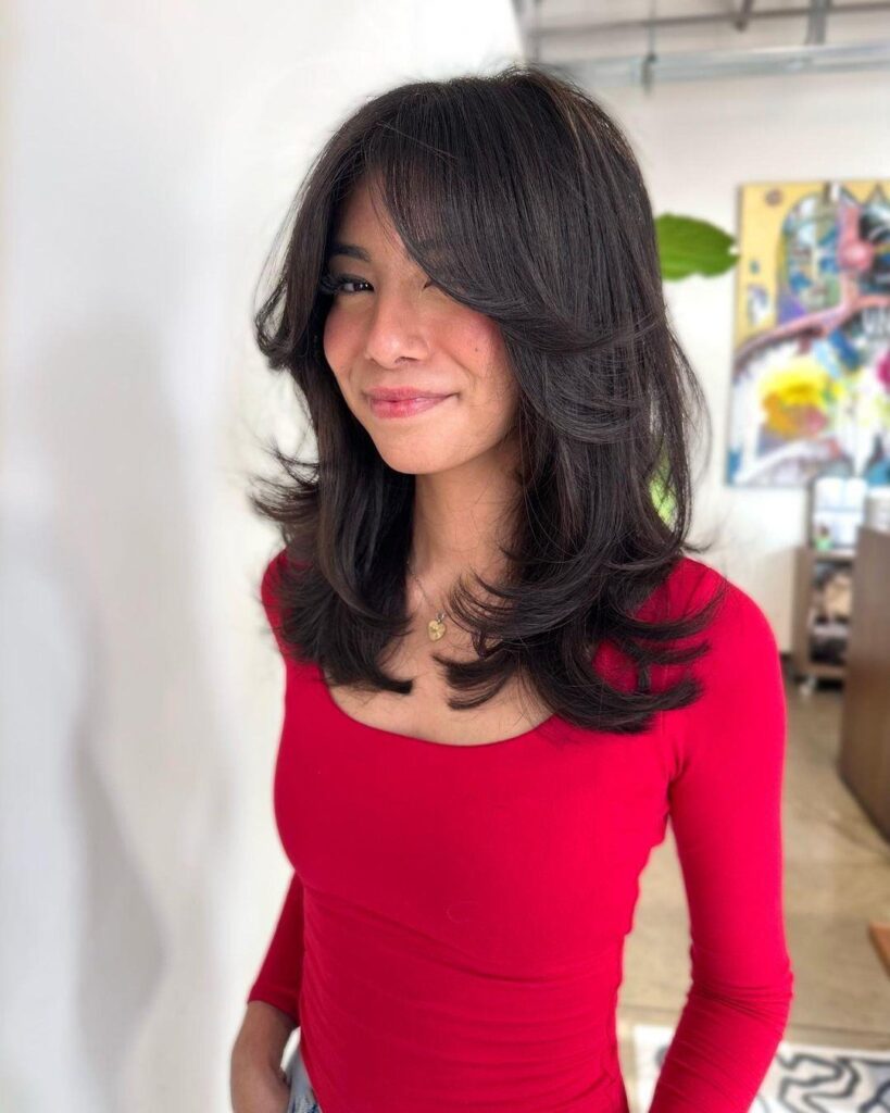 Mid Length Hair With Face-Framing Layers and Curtain Bangs