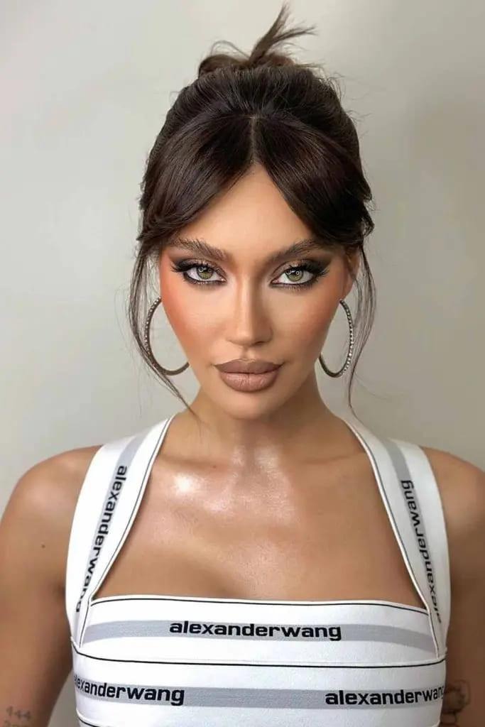 High Bun With Curtain Bangs