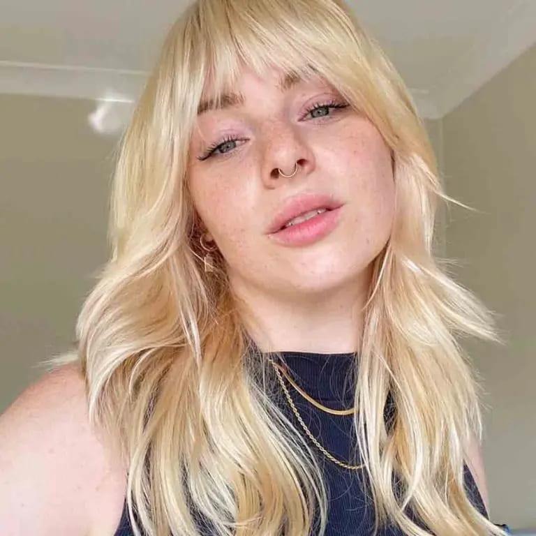 Long Blonde Wavy Wolf Cut With Asymmetric Bangs