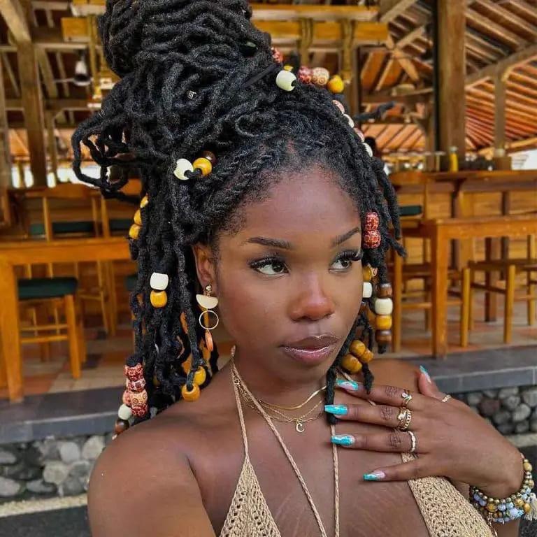 Beads With Messy Dreadlock Bun on Long Black Hair