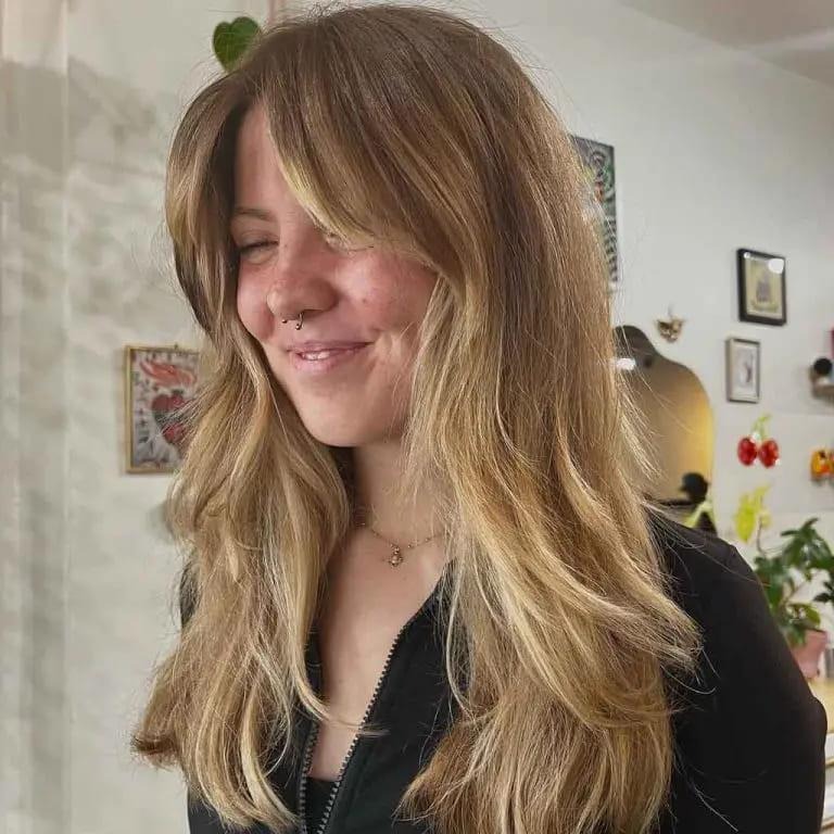 Layered Shaggy Blonde Haircut With Curtain Bangs