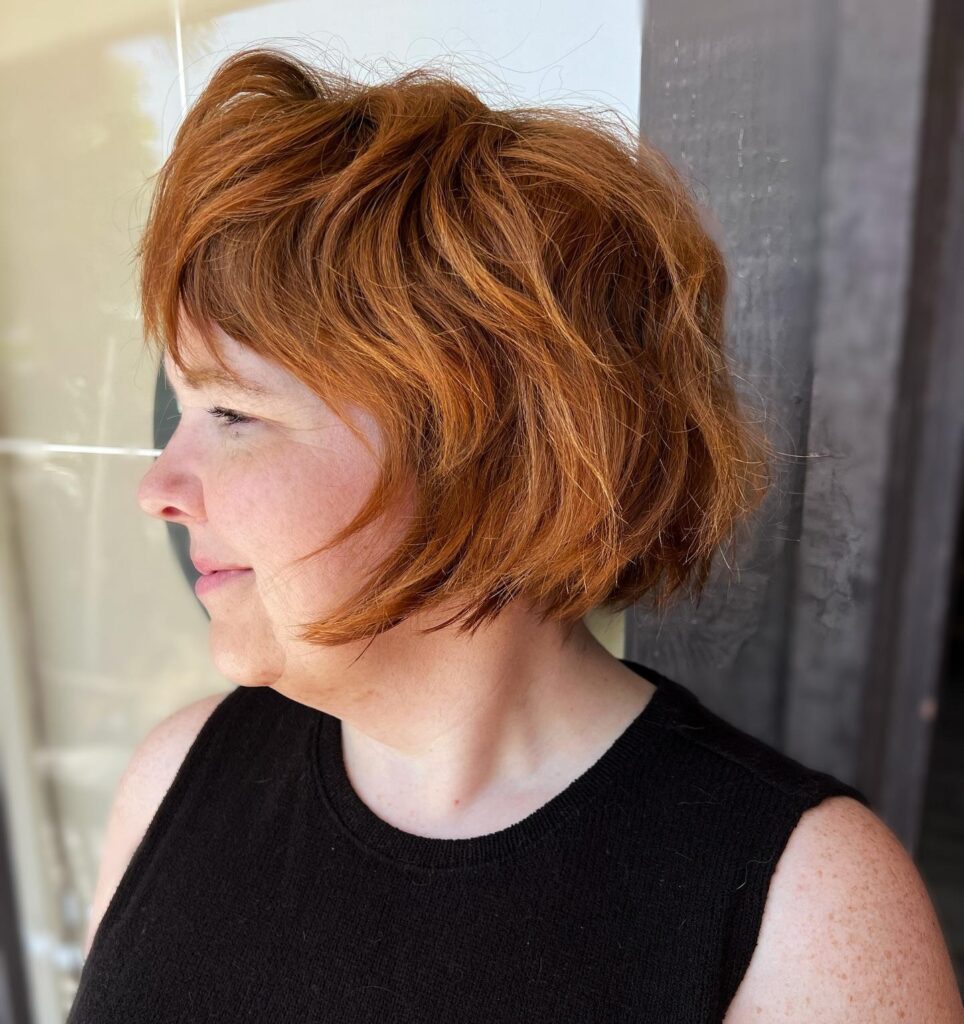 Orange Pixie Blowout Haircut With Bangs and Layers