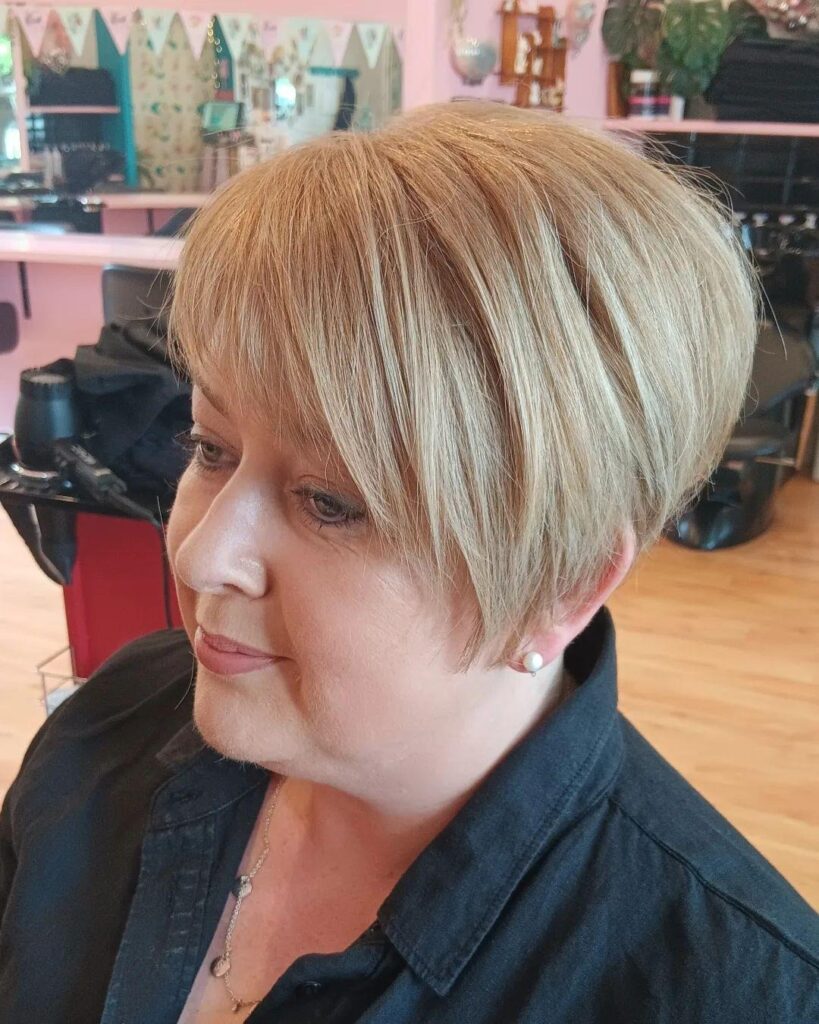 Side-Swept Blonde Pixie Cut with Extended Bangs