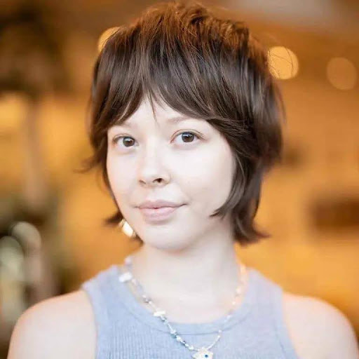 Soft Pixie Wolf Cut on Caramel and Dark Brown Hair With Dense Curtain Bangs