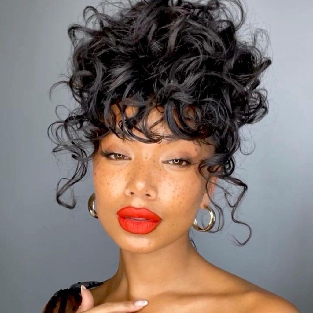 Medium Curly Messy Bun WIth Curly Bangs