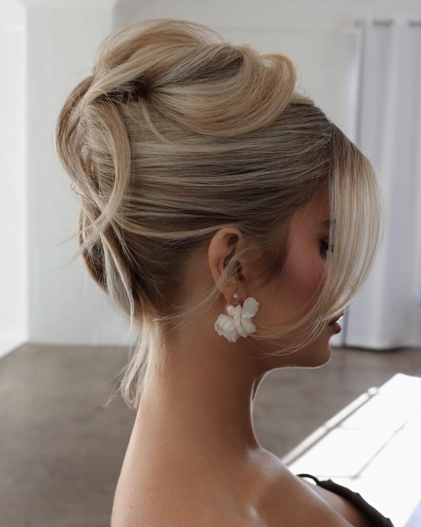 Blonde Messy Bun Updo With Face-Framing Tendrils