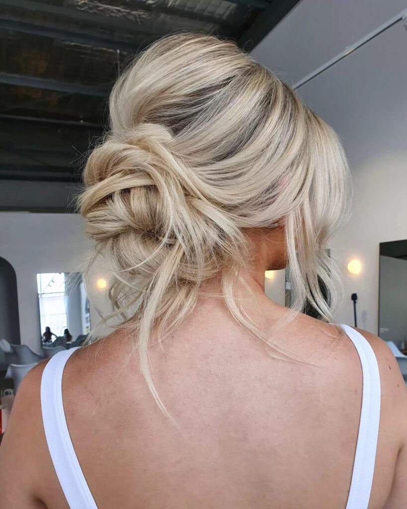 Wavy Messy Blonde Bouffant Bun With Tendrils