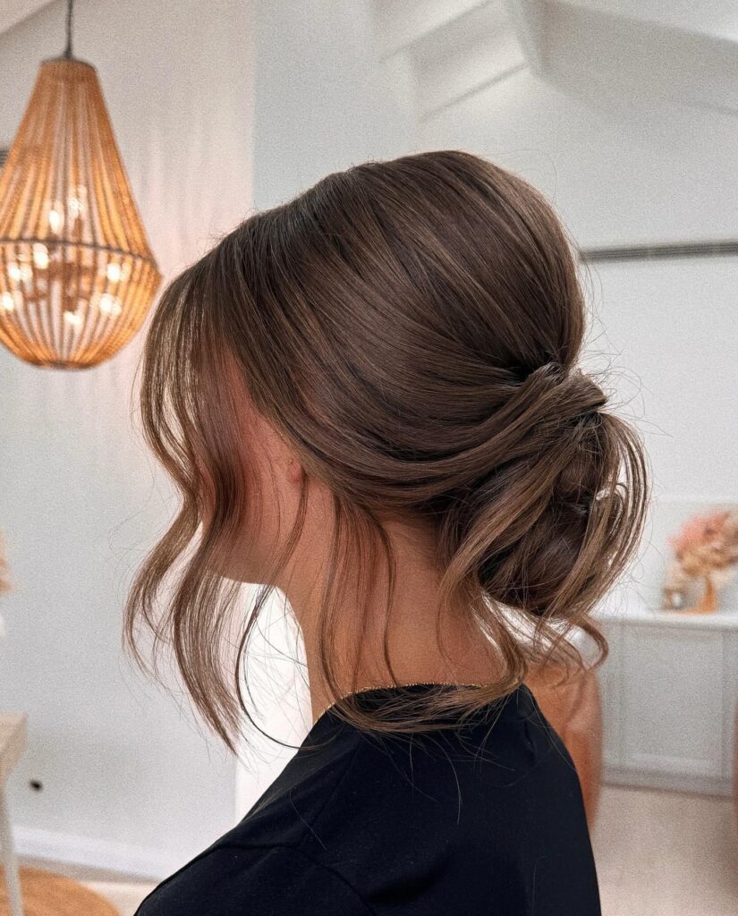 Tucked Chignon With Wavy Tendrils